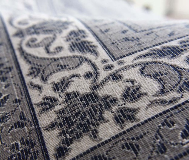 If you look at the back of a rug, you can find out if it is machine-made or hand-woven. 
